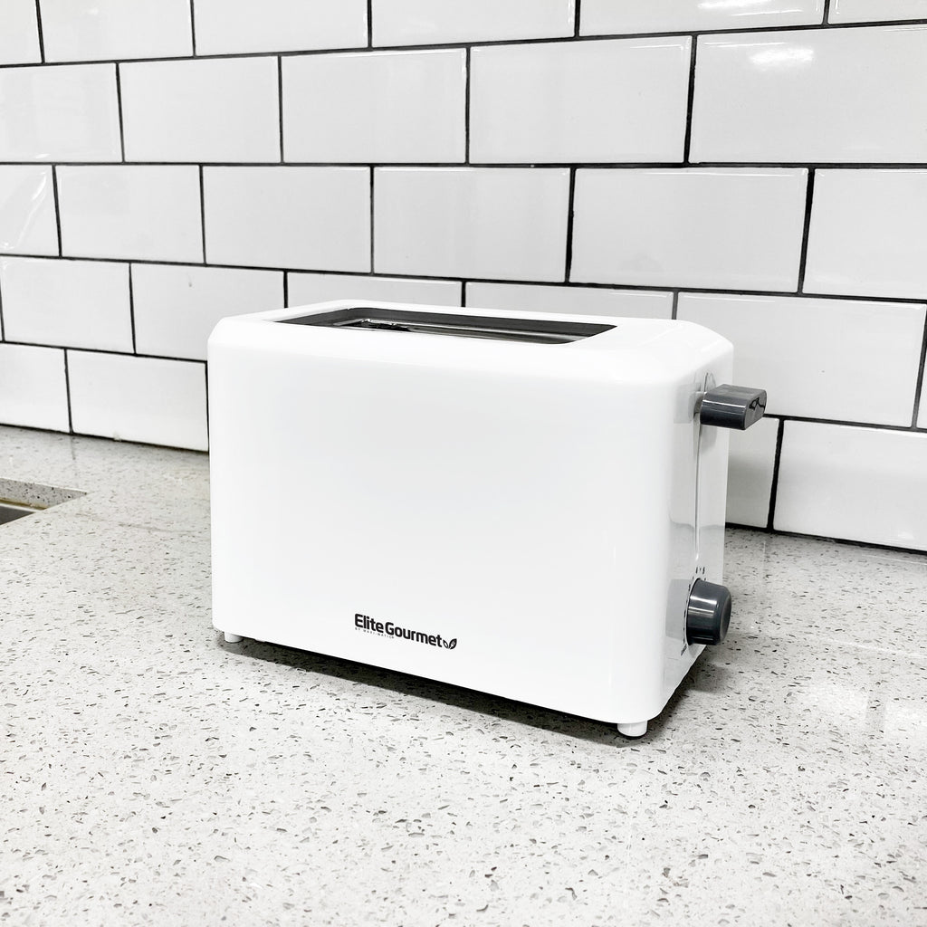 The 2 slice white toaster placing on a marble countertop. 