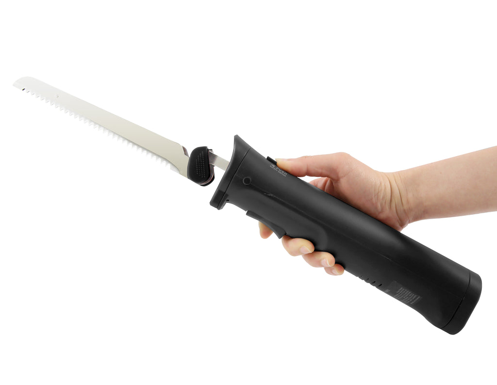 User's hand is gripping electric knife.