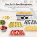 Your Go-To Food Dehydrator Prepare 100% all-natural dehydrated foods and snacks with no added sugars, additives or preservatives. Image showing various types of sliced fruits on dehydrator trays.