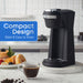 Compact Design Sleek & Easy to Store. Elite Gourmet coffee maker on the table with coffee cup and donuts.