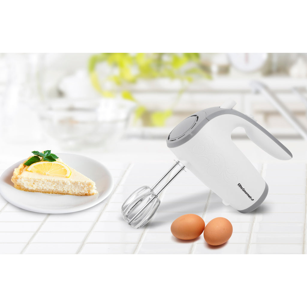 Image showing 5 Speed Hand Mixer with eggs and cake on the white floor.