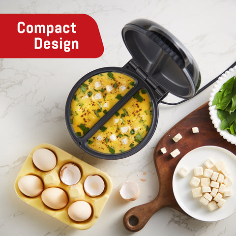 Compact Design.  Overhead view of Omelette Maker surrounded by ingredients.