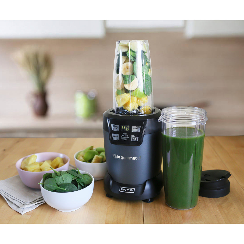 Smart Blender on kitchen counter preparing a green smoothie with ingredients.
