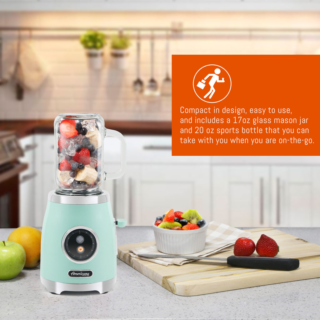 Compact in design, easy to use, and includes a 17oz glass mason jar and 20 oz sports bottle that you can take with you when you are on-the-go. Showing 17oz Retro Mason Jar Personal Blender on the countertop with slices of fruits.