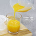 SEAMLESS TRANSPORT Juice container lifts from base for easy serving. Orange juice transferring into the glass. 