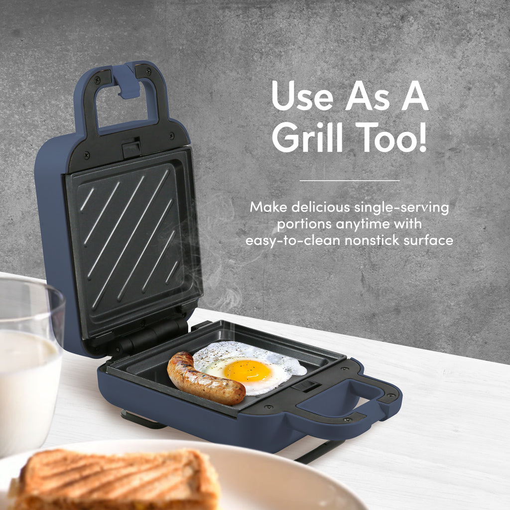 Use As A Grill Too! Make delicious single-serving portions anytime with easy-to-clean nonstick surface. Image showing nonstick Mini Waffle Breakfast Maker with egg and sausage.