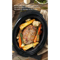 Removable stoneware slides right out of the base for easy transport to the table or storage in the fridge. Large roast and vegetables are cooking inside inner pot.